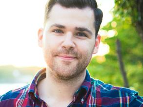 A white man wearing a plaid shirt
